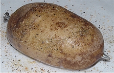 Spud Spikes in a potato with Spud Spikes Gourmet Original Blend Potato Skin Rub and Everyday Seasoning